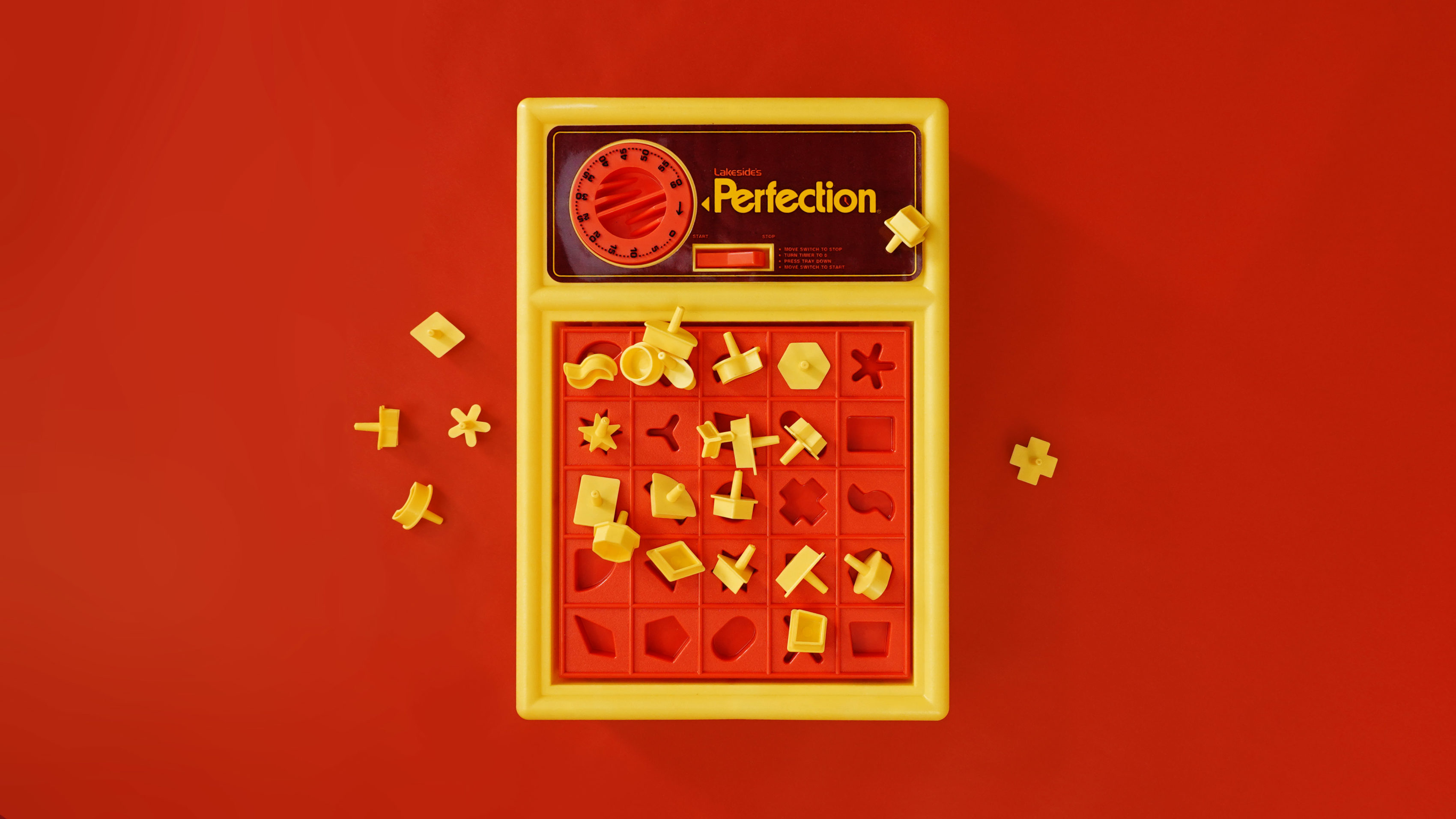 Perfection Game with pieces strewn about