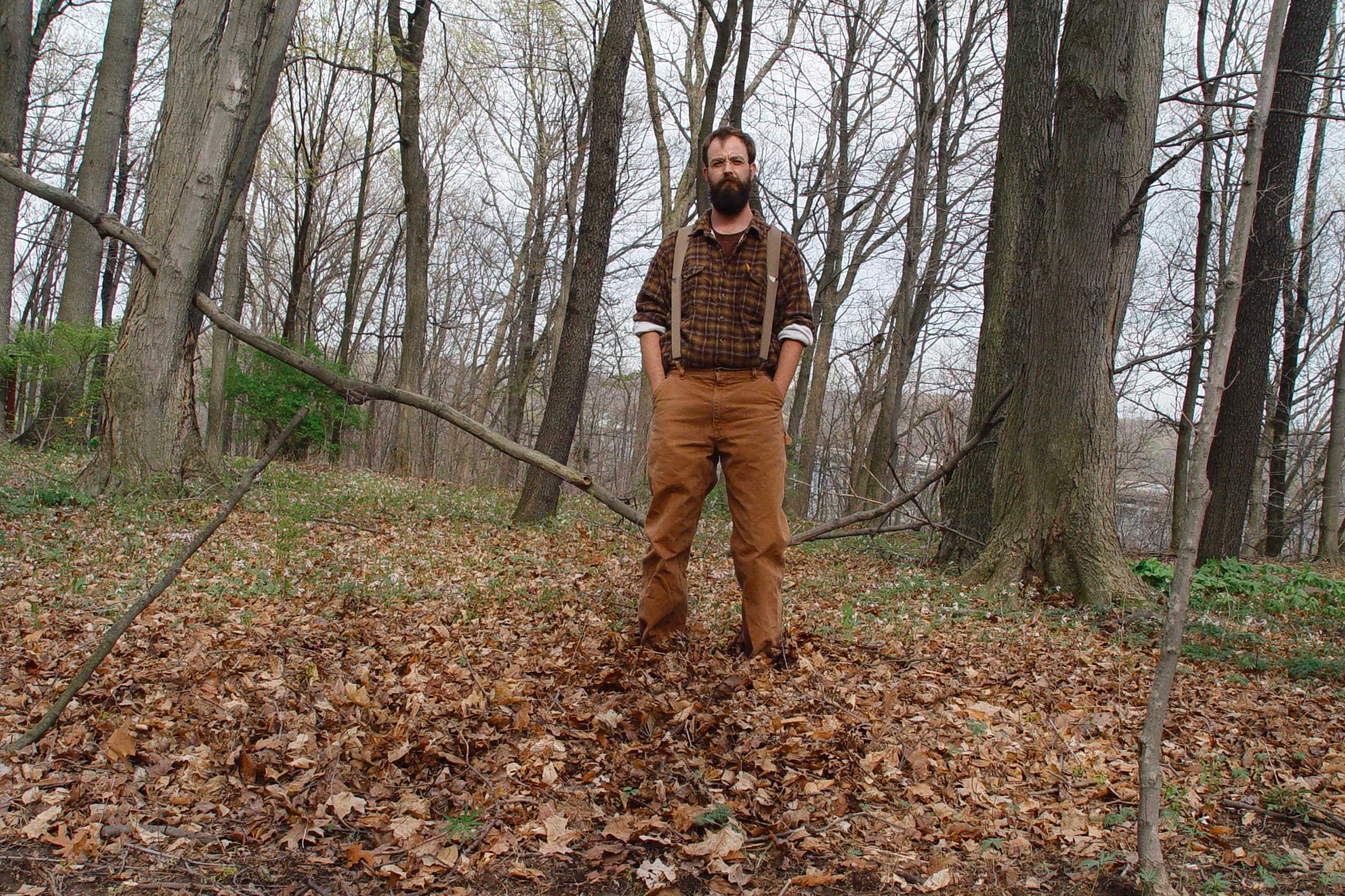 Man in suspenders standing in autumn