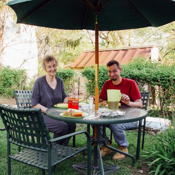 Mother and son have dinner out in the garden