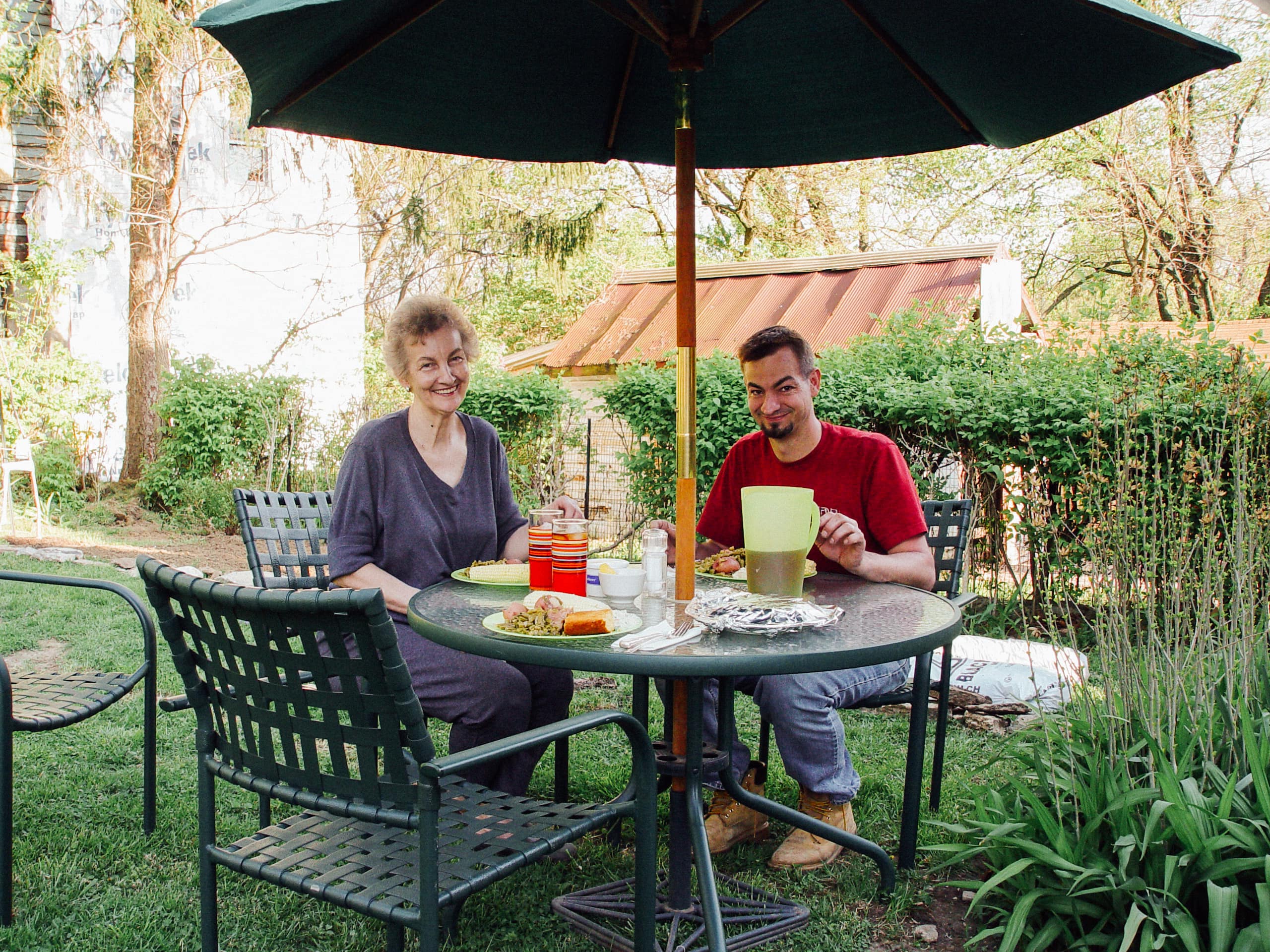 Mother and son have dinner out in the garden