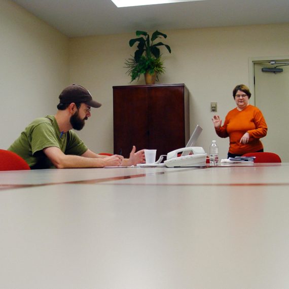 A man sits at a conference table