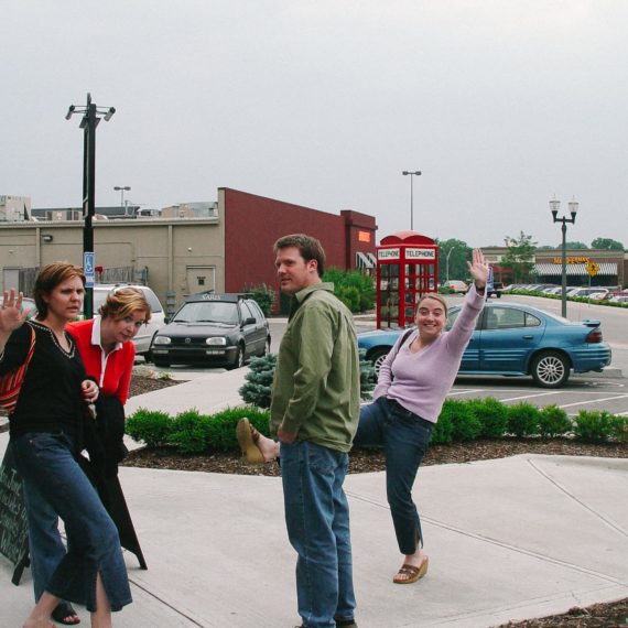 Folks stand outside a pub