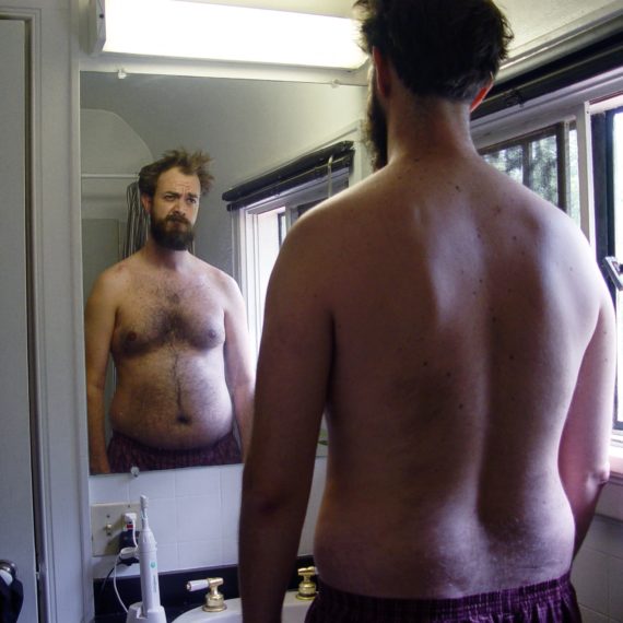 Man looks in mirror