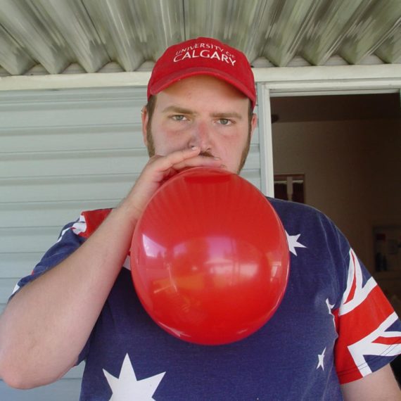 Man inflates red balloon