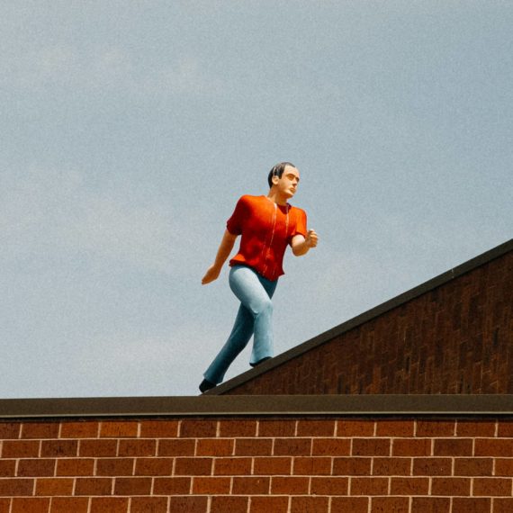 "Walking Man (On the Edge)" by Jonathan Borofsky sculpture on top of building