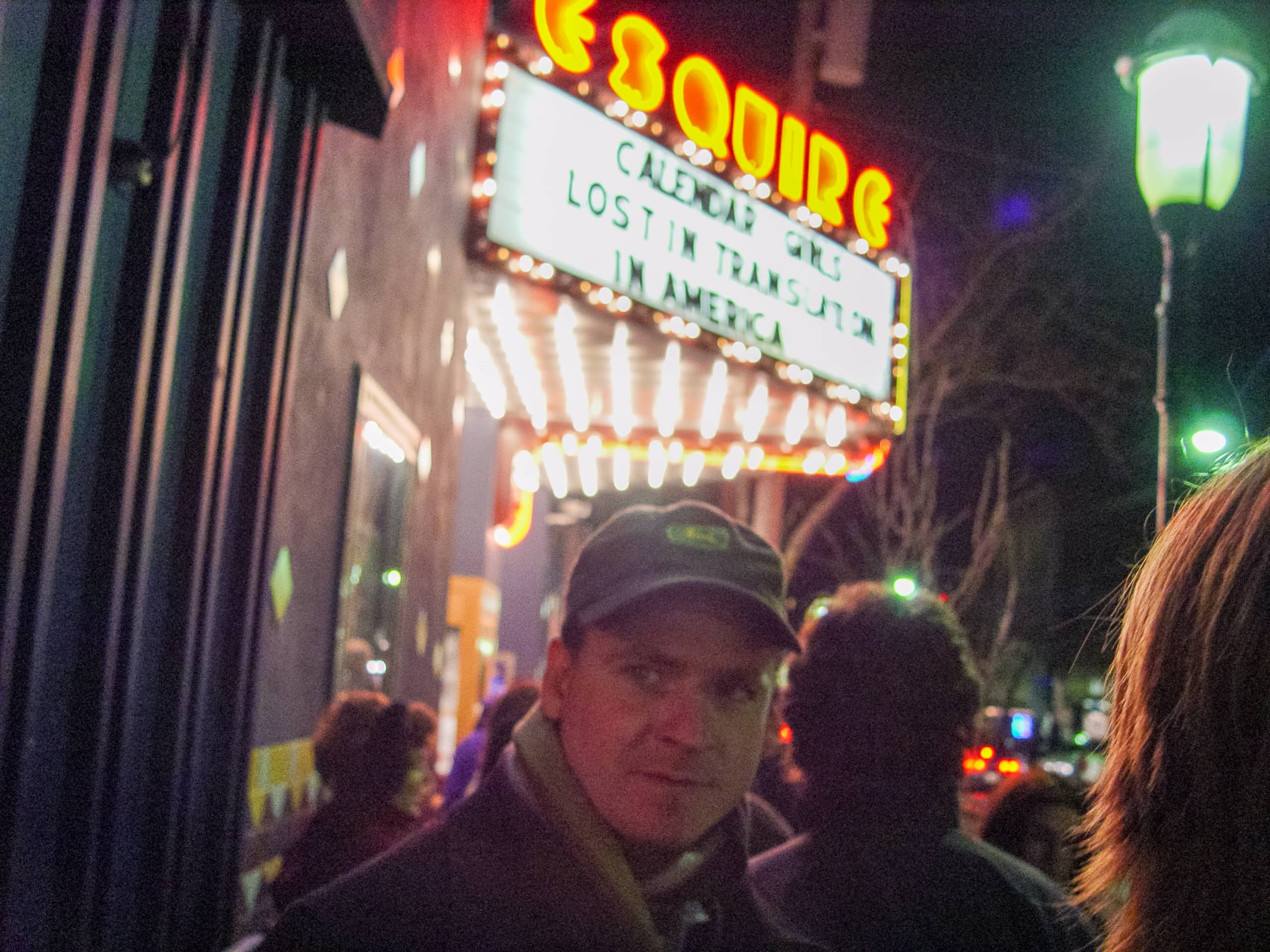 Man in front of movie theater marquee