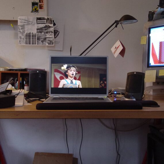 Whale Rider DVD playing on laptop on messy desk