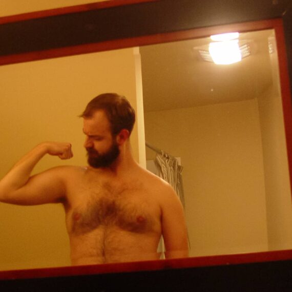 Man flexes in mirror