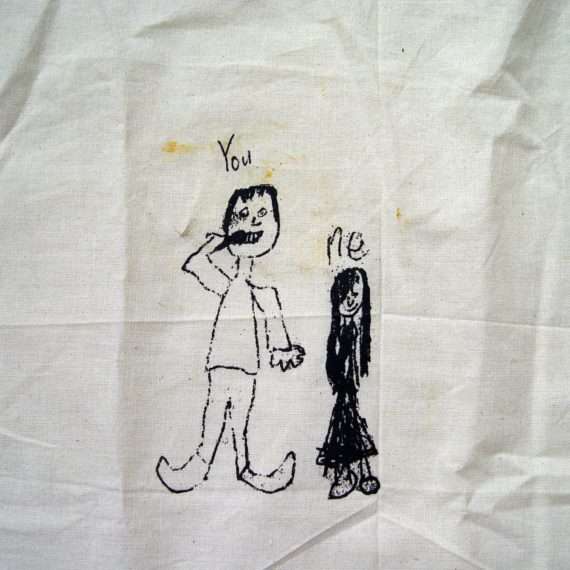 A tote with kids drawing of two people that says You and Me