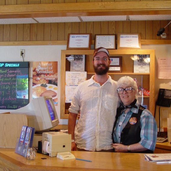 A man stands next to an iHop hostess