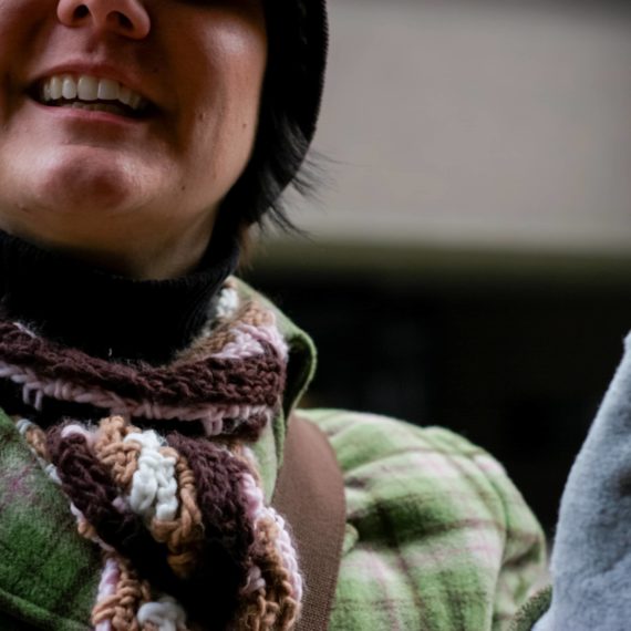 Woman with scarf and plaid coat