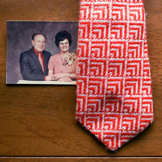 A photograph of a man and wife. His tie matches her dress.