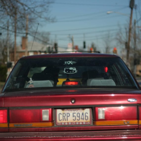 Ford Escort with Hello Kitty and WOXY stickers in read window