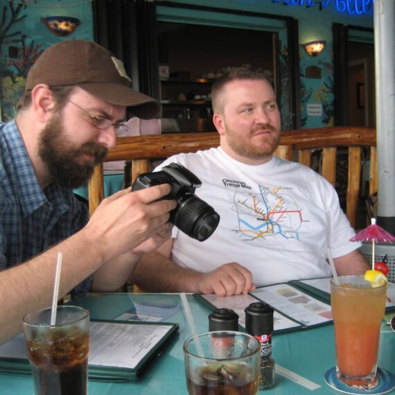 Man chimps at digital camera at restaurant