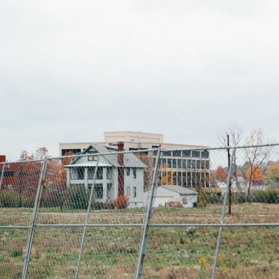 House surrounded by chain-link fence