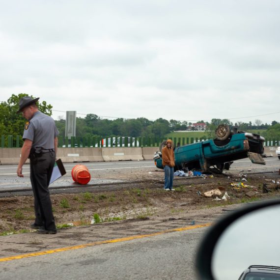 a truck flipped in the median of the highway