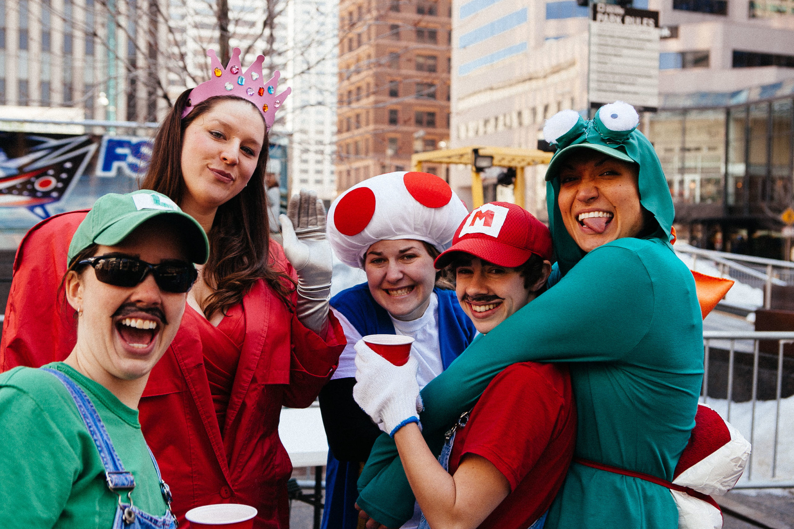 Folks dressed up in Super Mario and Luigi and Mushroom costumes