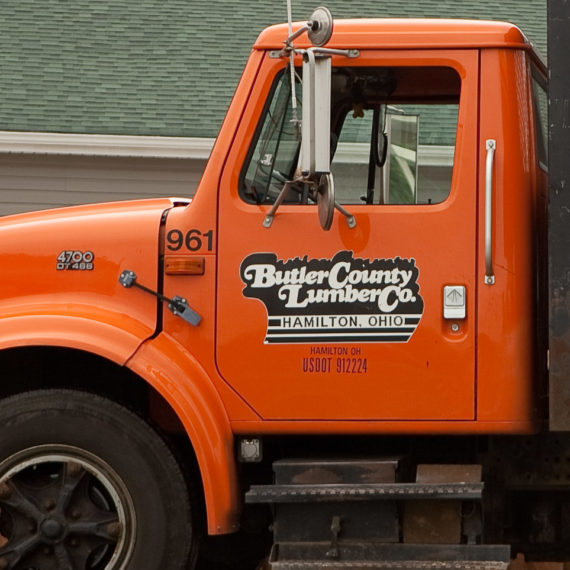 Orange truck with a logo set in a swash typeface