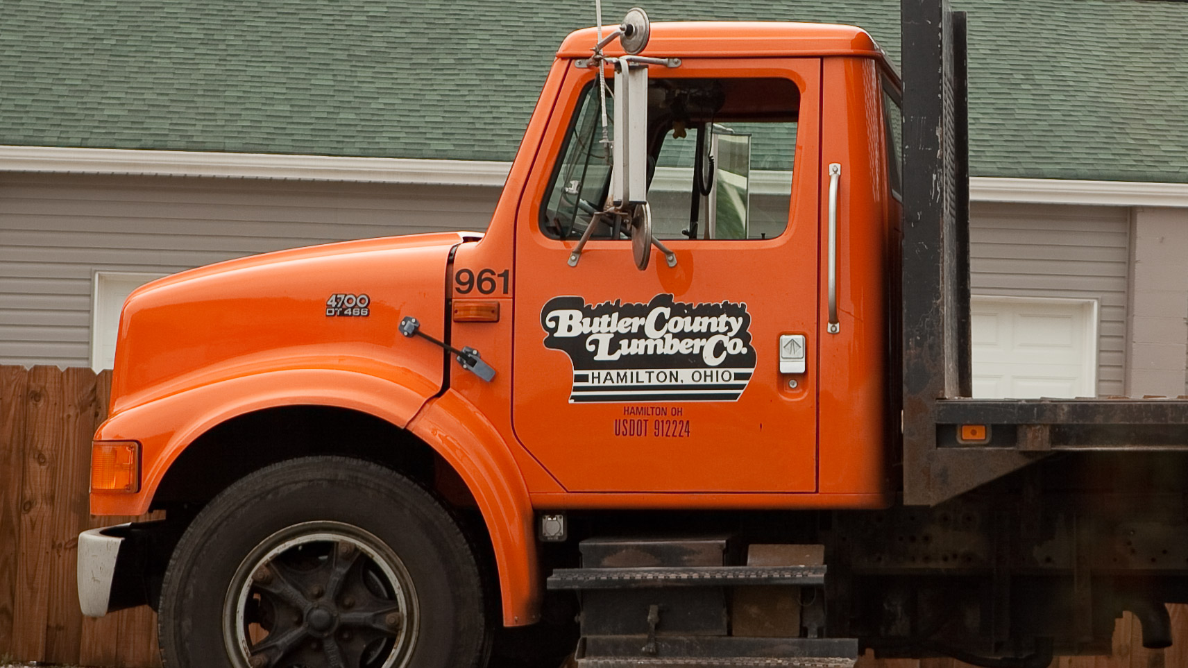 Orange truck with a logo set in a swash typeface