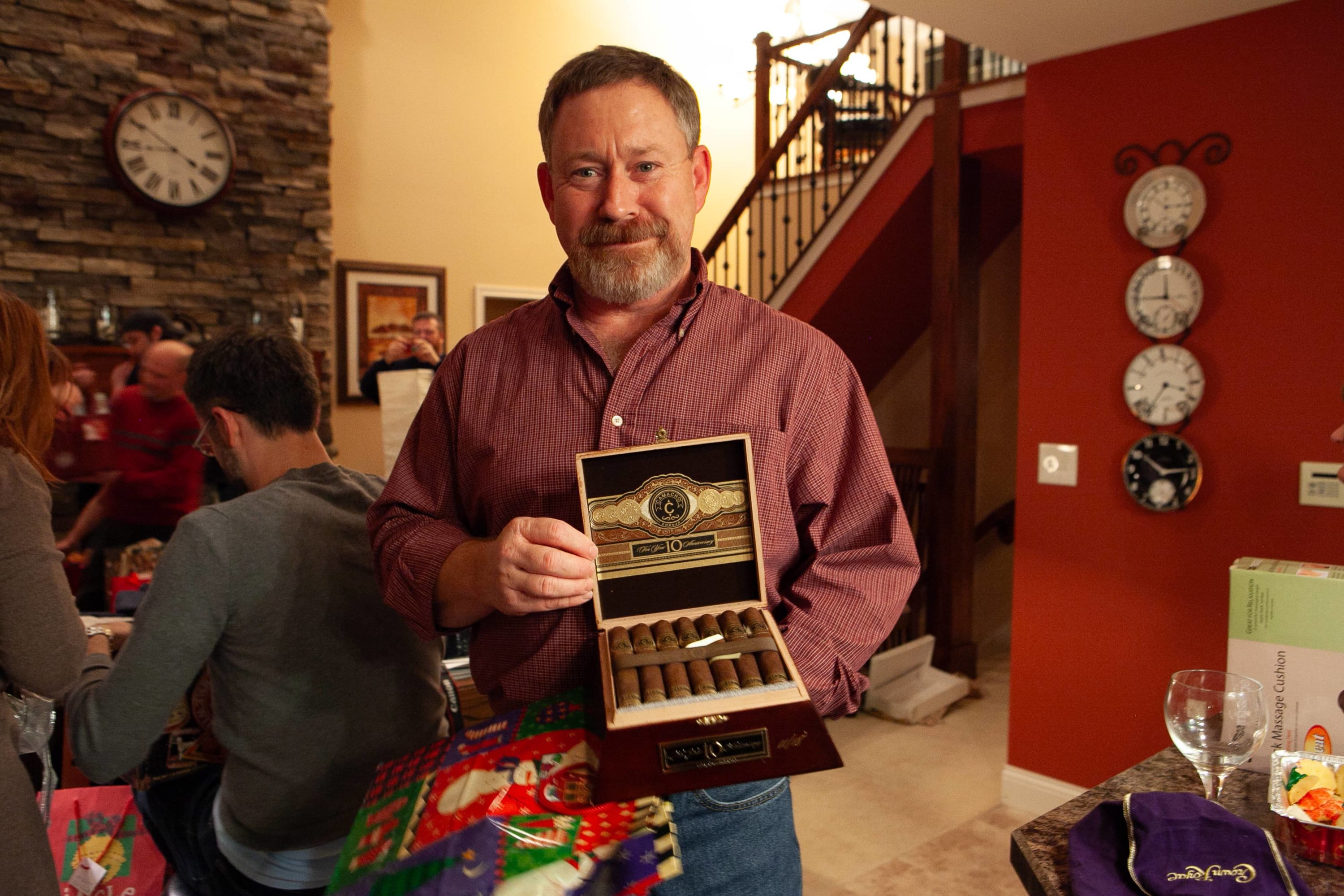 Man holds box of cigars