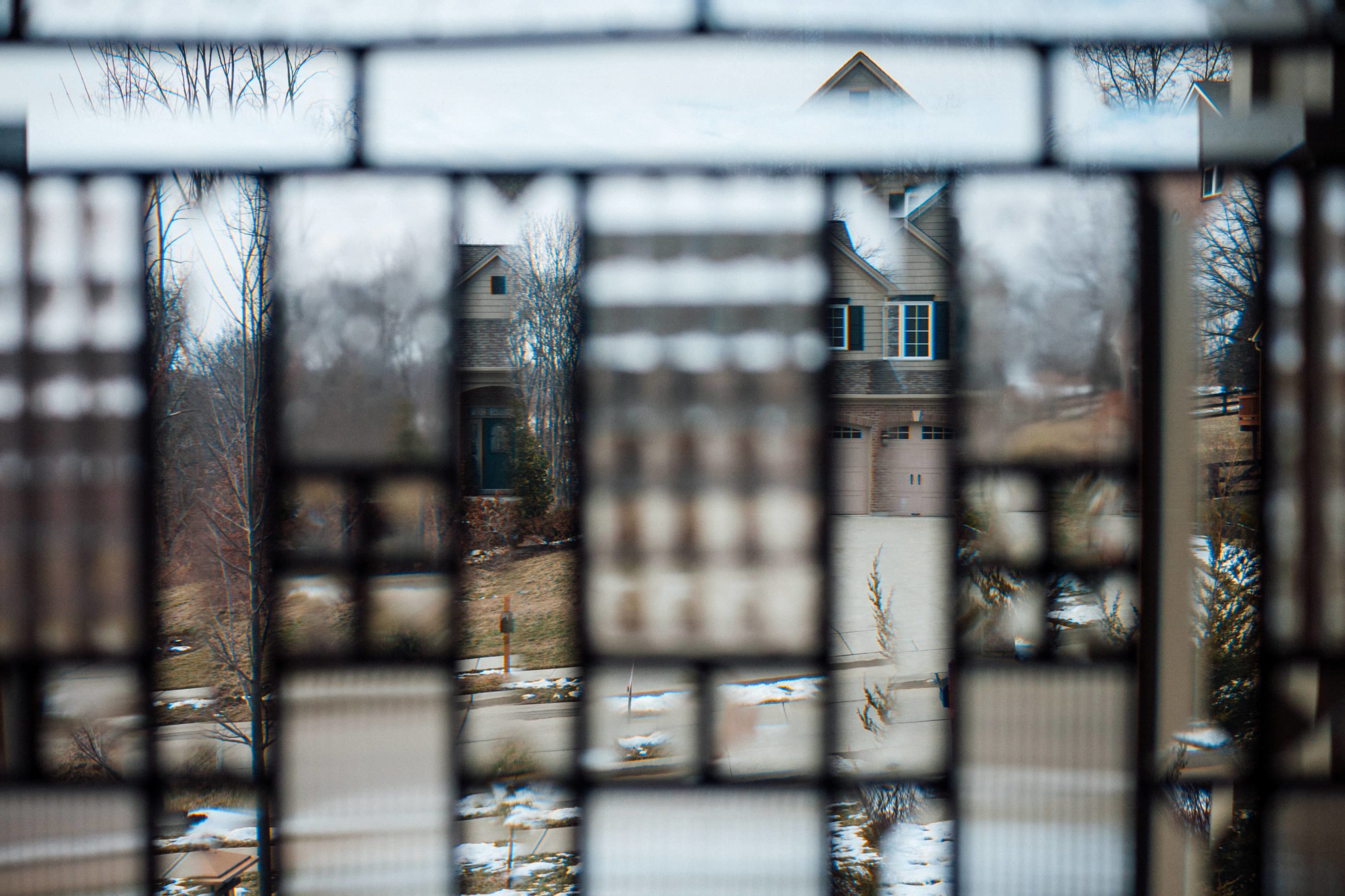 View of suburban house through faceted glass front door window