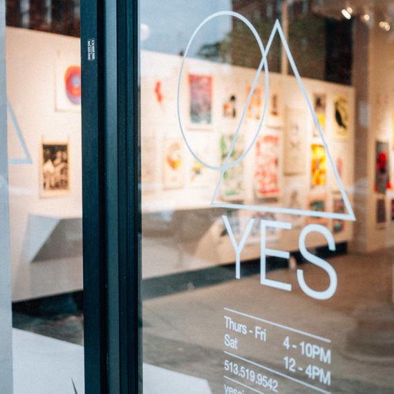 A gallery with the word YES on the door with a circle and triangle