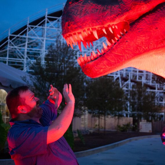 Man about to be eaten by fake T-rex