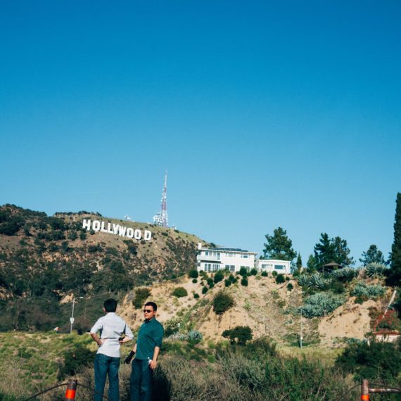 Hollywood sign with two unknown tourists