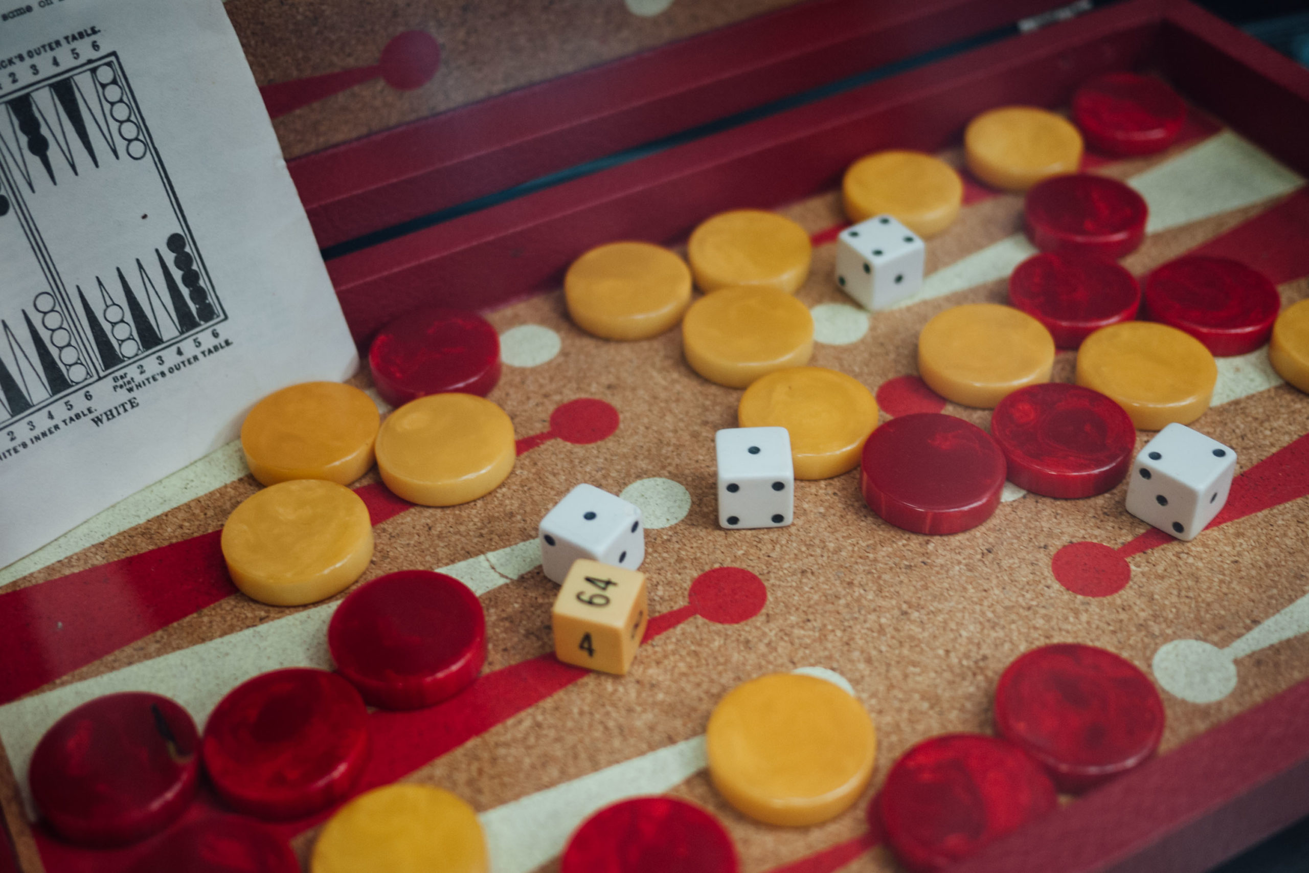 A vintage Backgammon set with red and yellow pieces