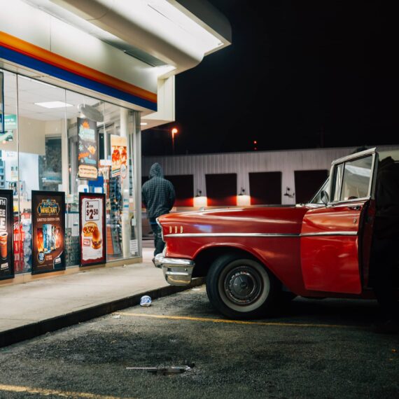 Red classic car at convenience store