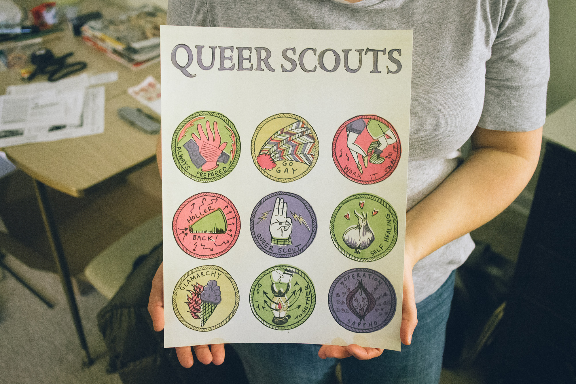 holding a queer scouts poster