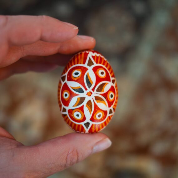 Person holding Easter egg ornately decorated