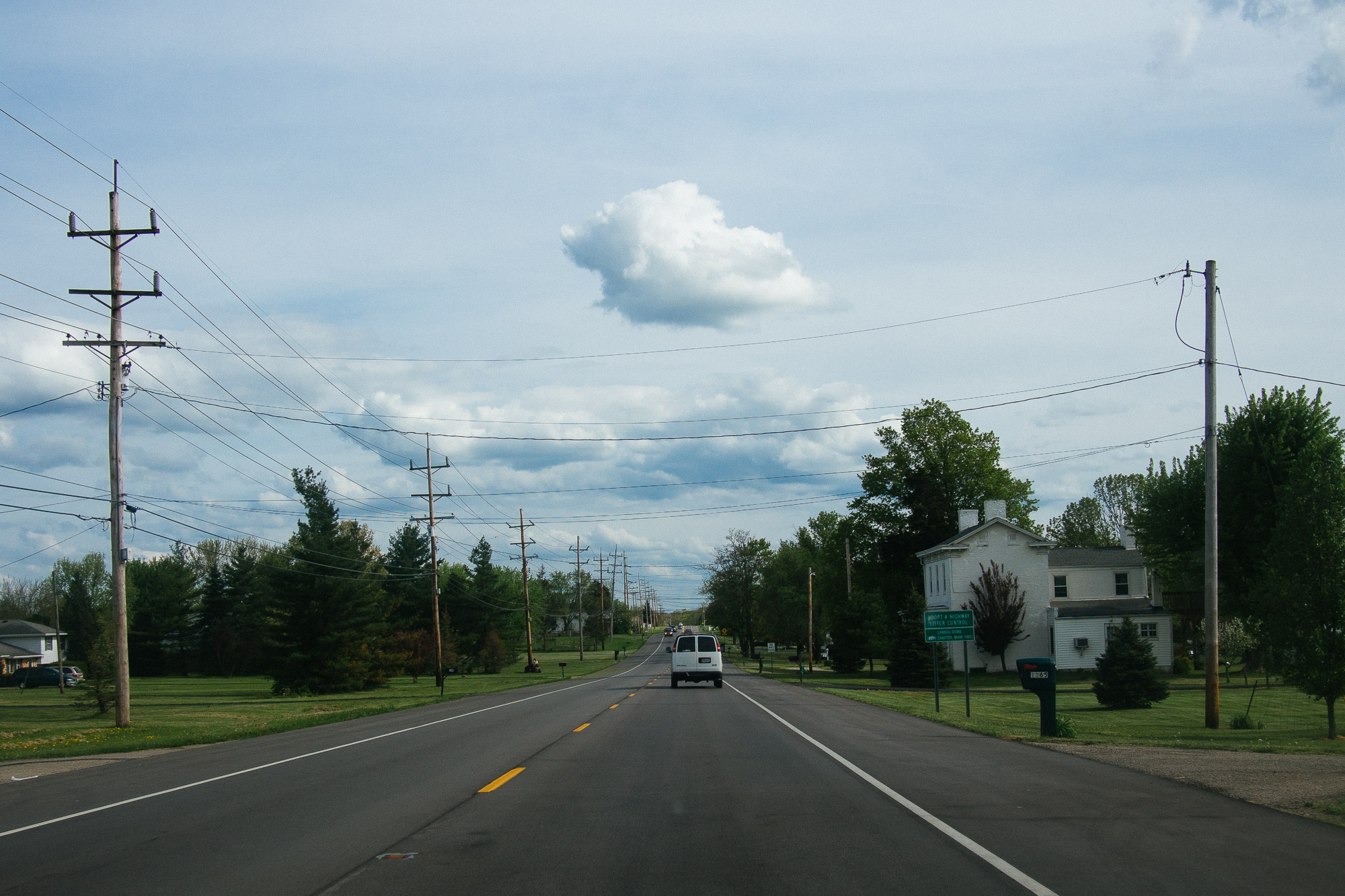 Cloudy skies above a two lane road