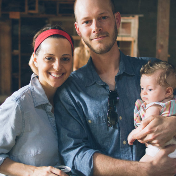 Two proud new parents and their young daughter.