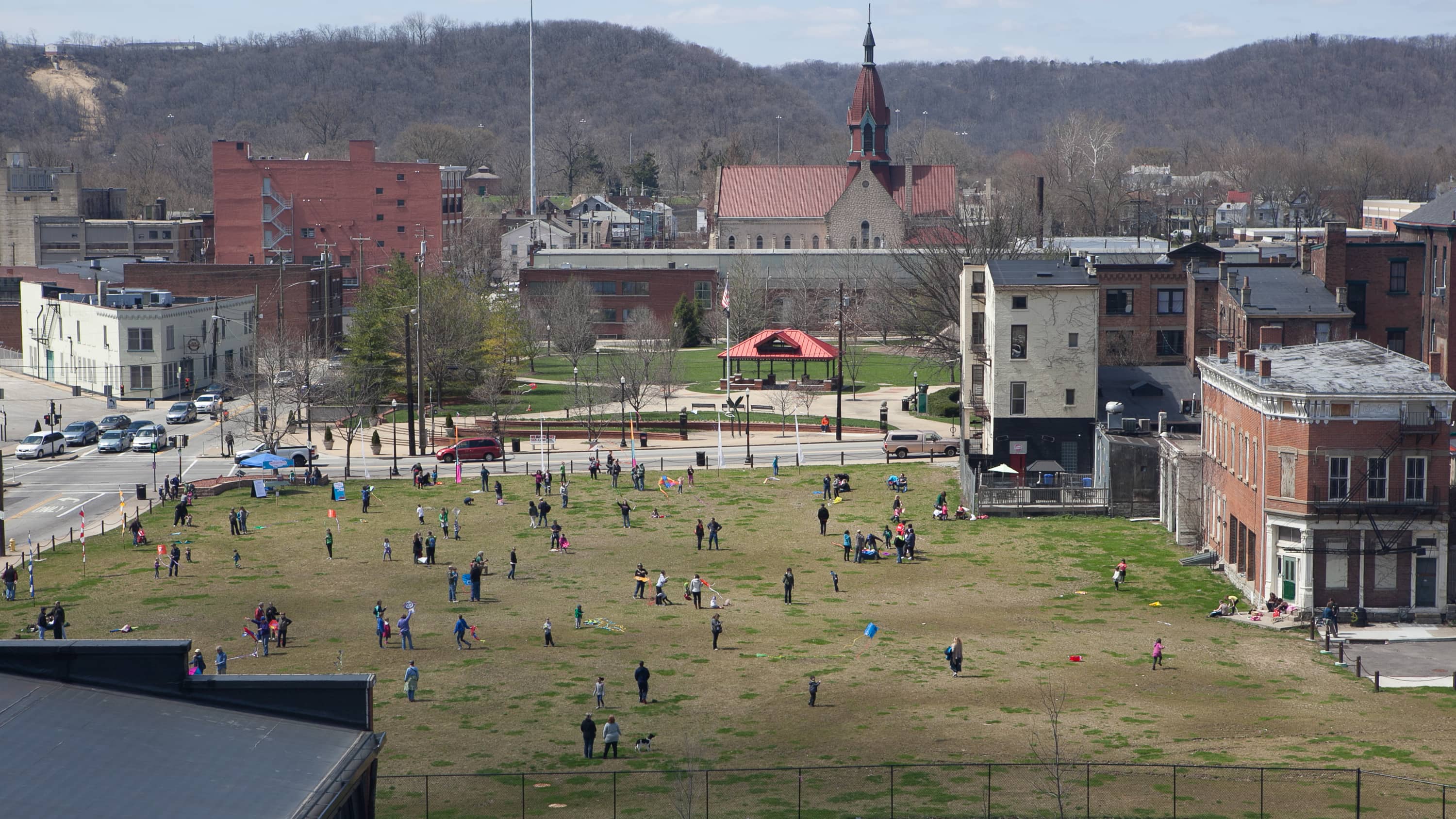 Folks gather to fly kites but there is no wind