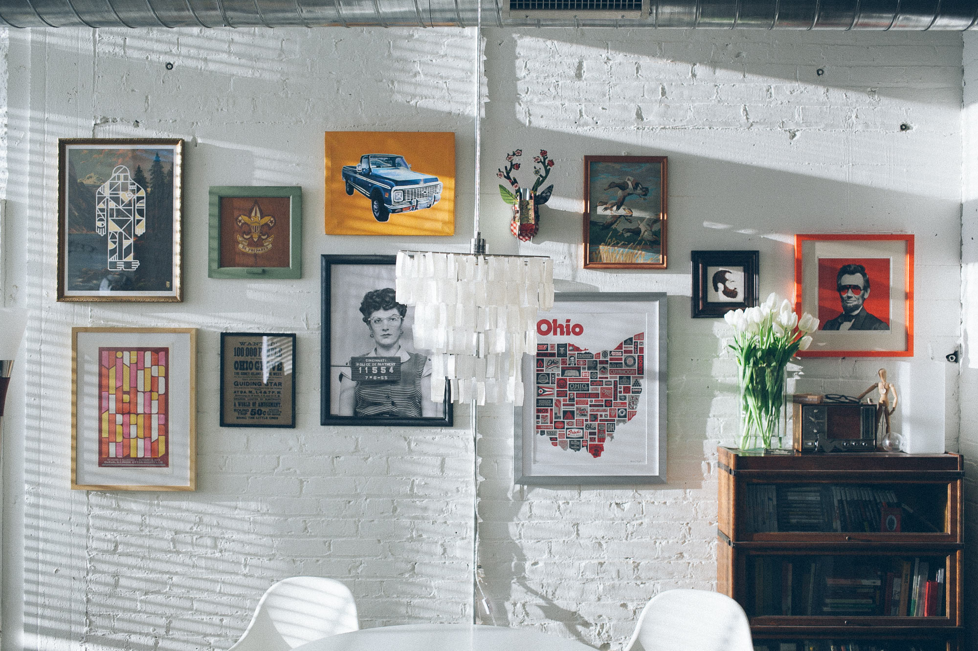 Prints hung on a wall in parlor style