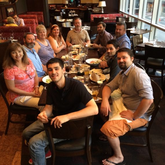 A large group of folks around a restaurant table