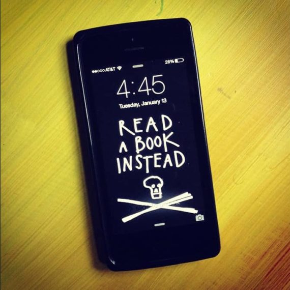 Wallpaper for phone that says Read a book instead with a skull and crossbones