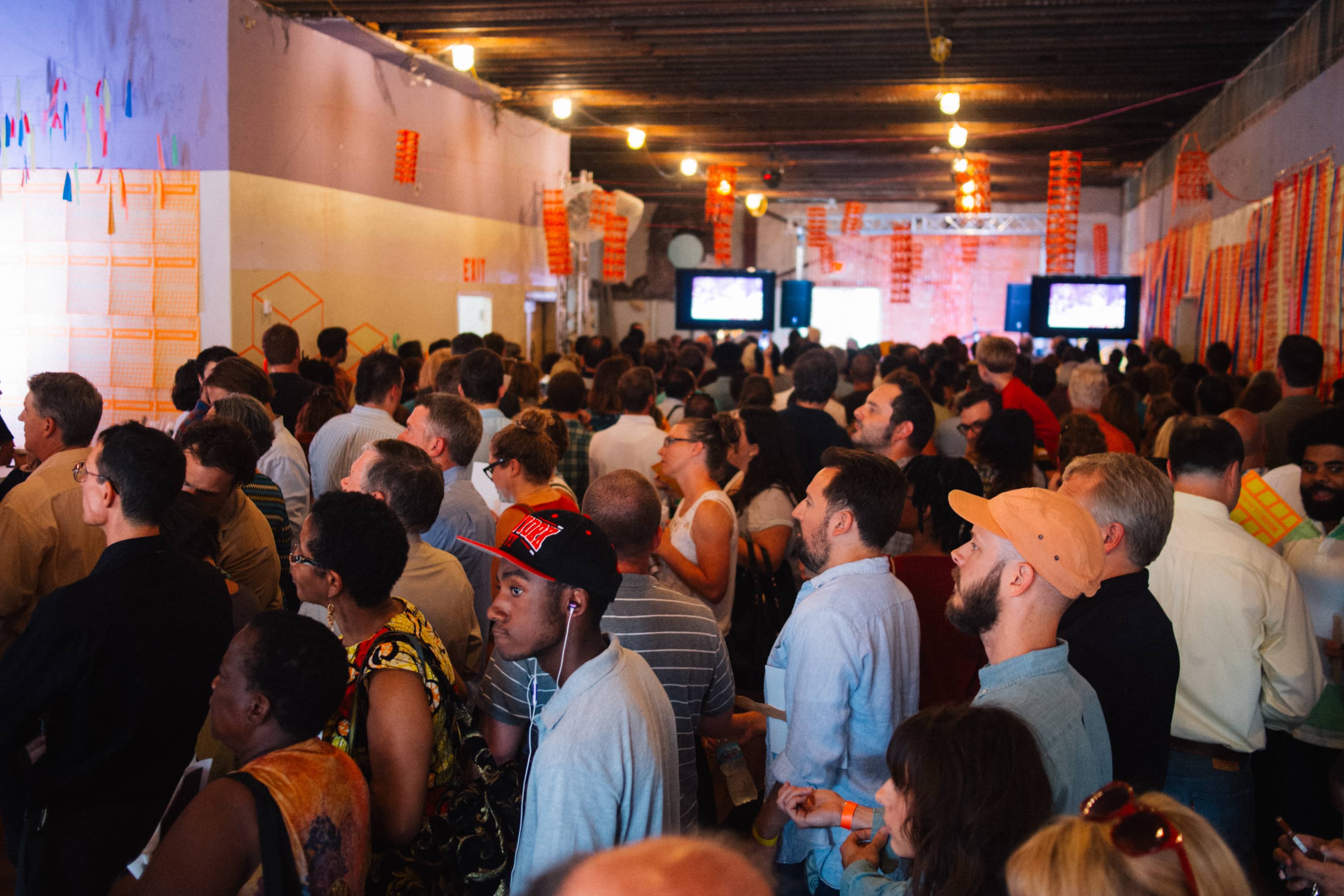 A crowd of people in a room under construction