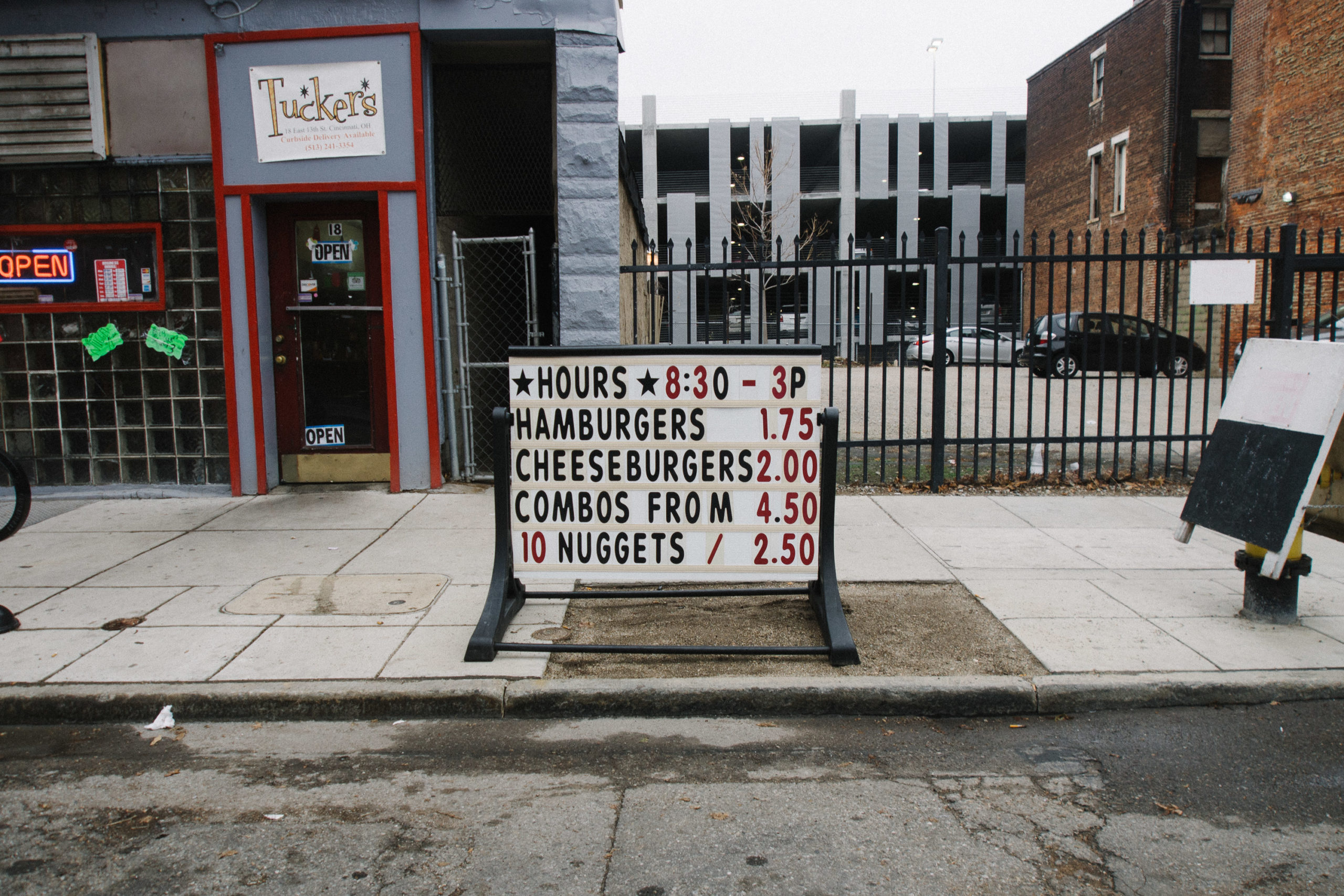 A menu sign with hamburgers and cheeseburger with their prices