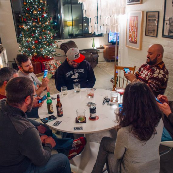 Folks playing a card game during the holidays