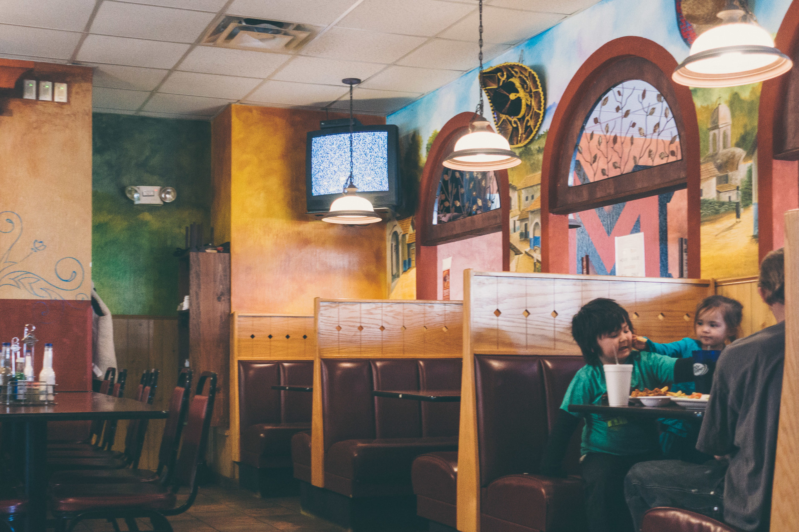 A Mexican restaurant interior with CRT television with static on the screen