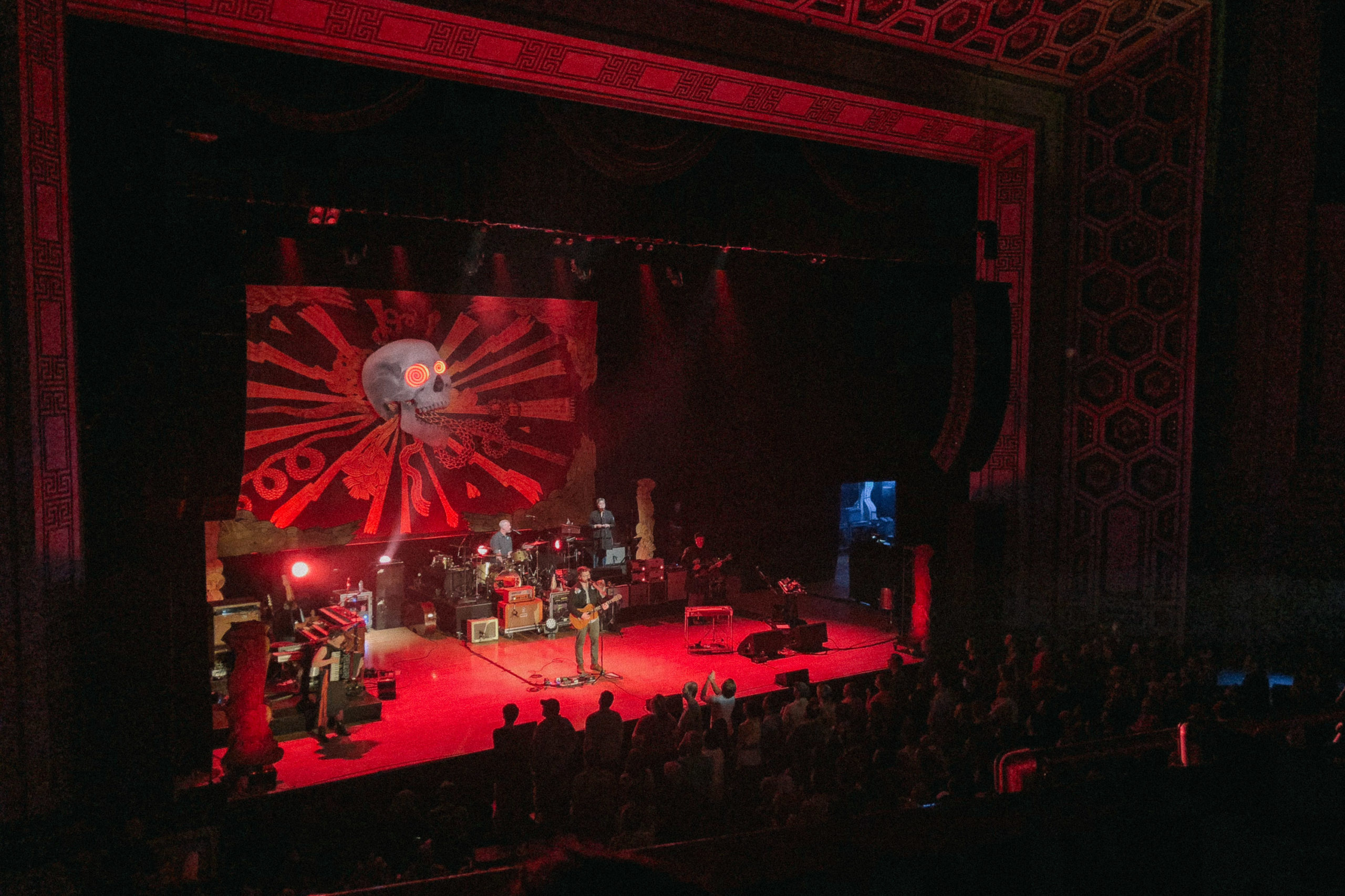 A band playing on stage bathed in red light