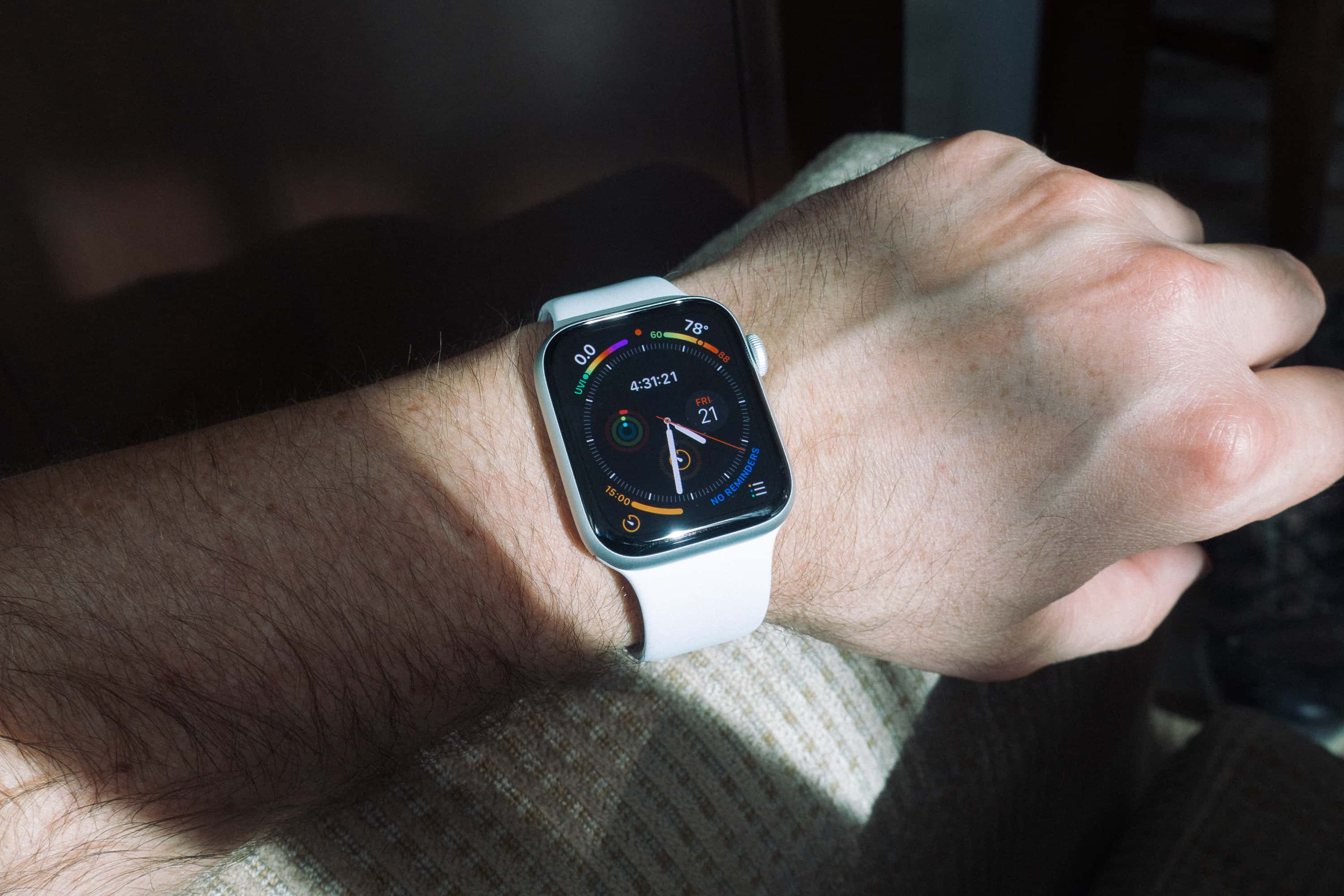 Left wrist with an Apple Watch with a stripe of light 