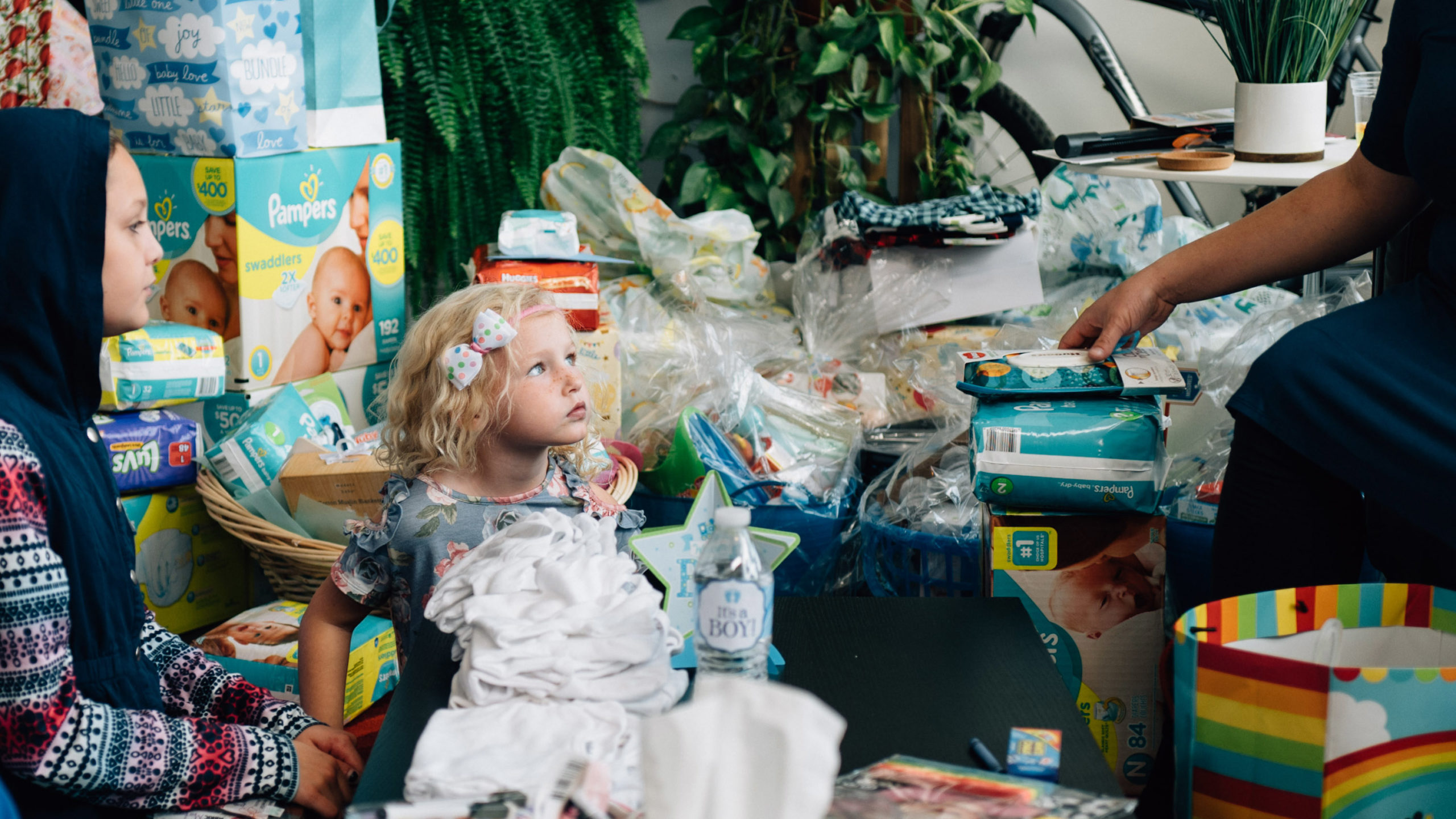 A young girl surrounded by gifts