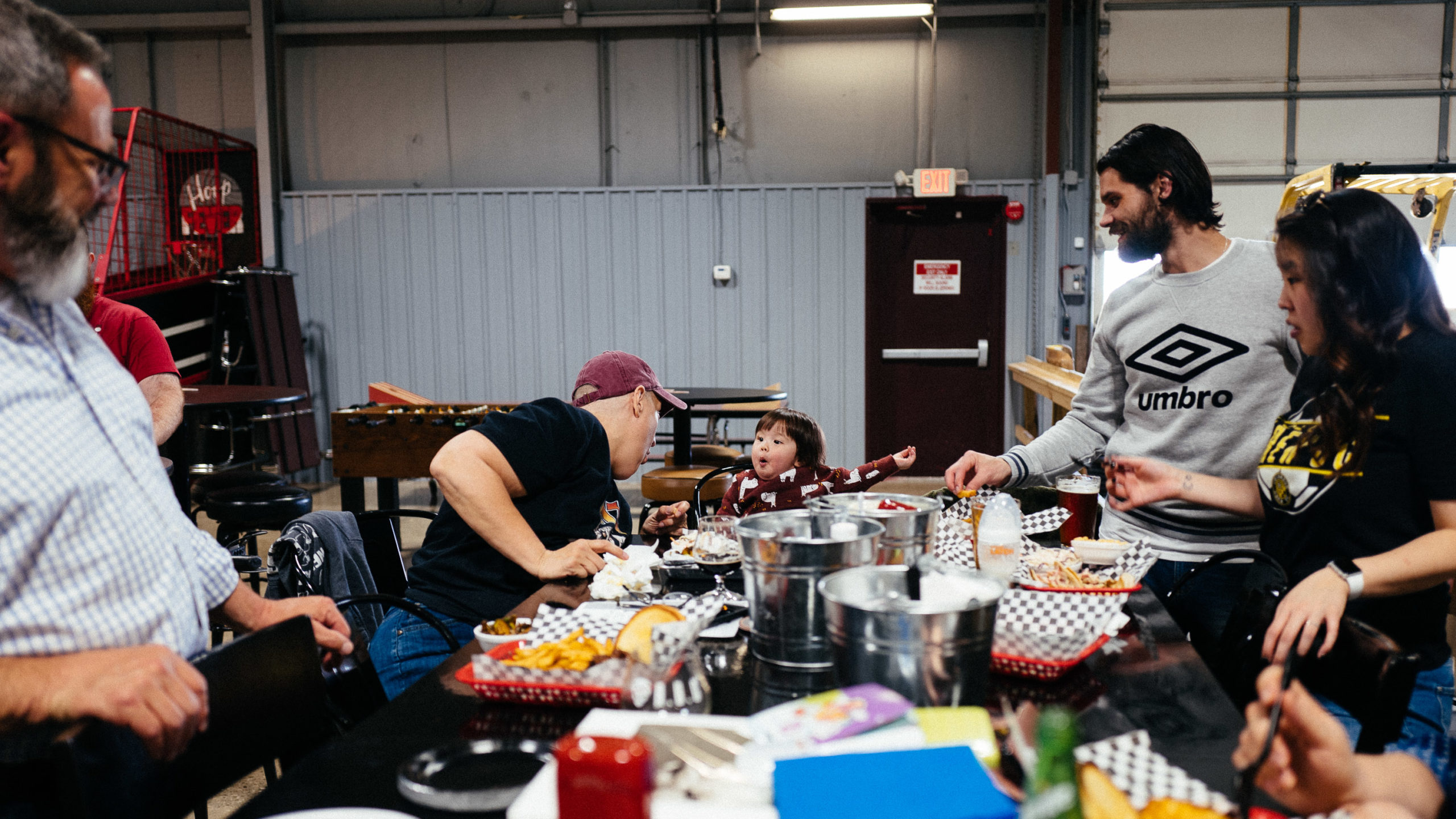 A young boy is excited at a table full of food