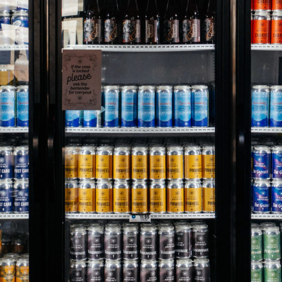 Canned beers in a glass front refrigerator