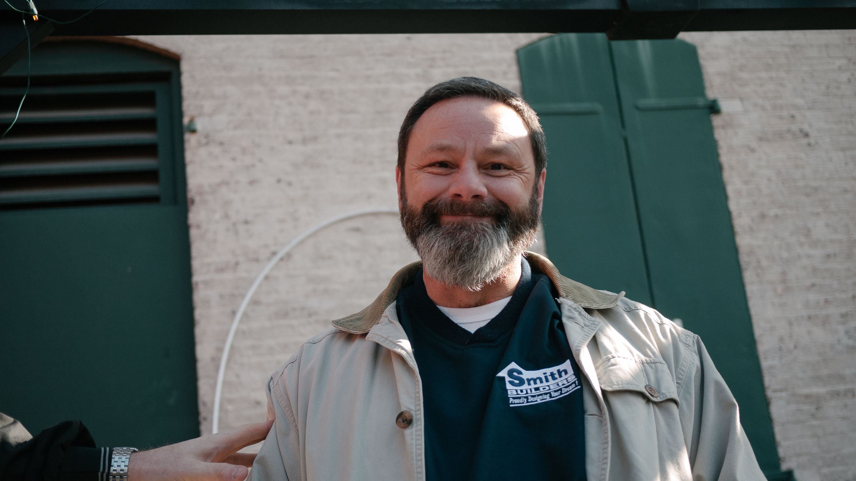 A smiling bearded man