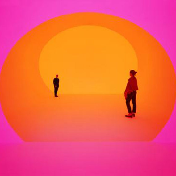 Figures stand washed in orange and pink light