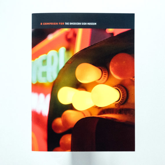 American Sign Museum prospectus cover featuring a photograph of a sign with light bulbs